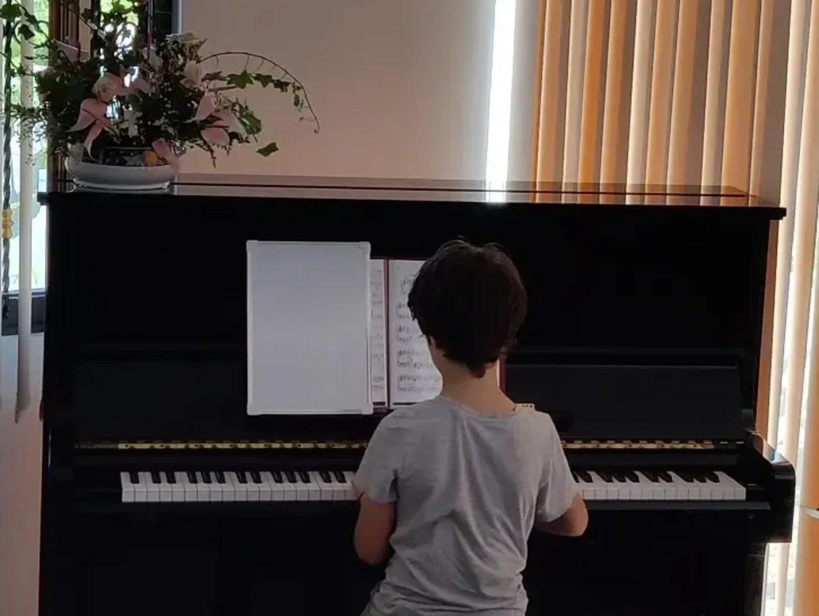 student at the piano